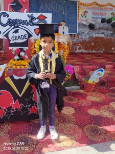 SCHOOL STUDENT HOLD TROPHY IN HAND